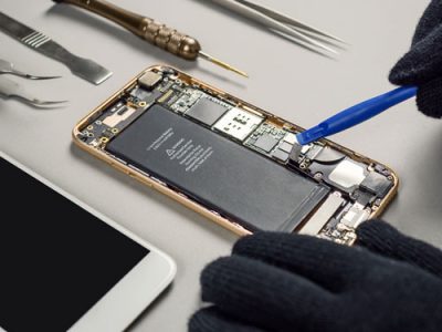 component-reclamation-technician-repairing-broken-smartphone-battery